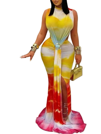 Woman wearing a colorful dress with a white background, holding a gold handbag.