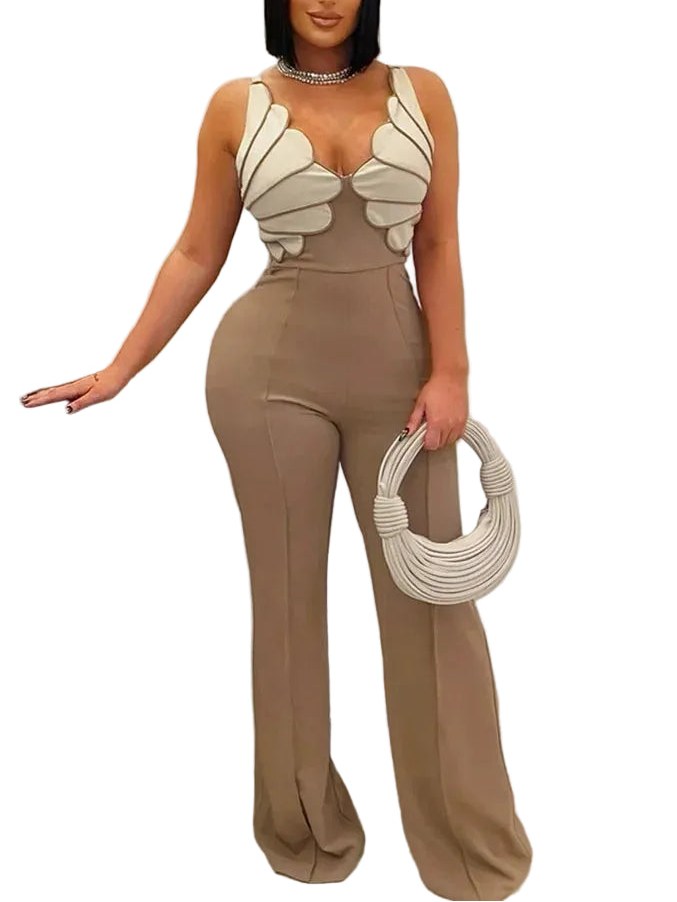 Woman wearing a beige jumpsuit with butterfly-like shoulder designs, holding a matching handbag.