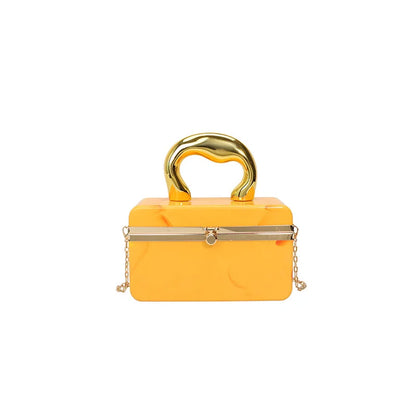 Yellow handbag with gold accents on a white background