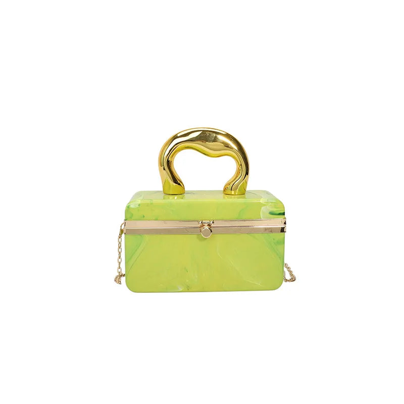 Green handbag with gold accents on a white background