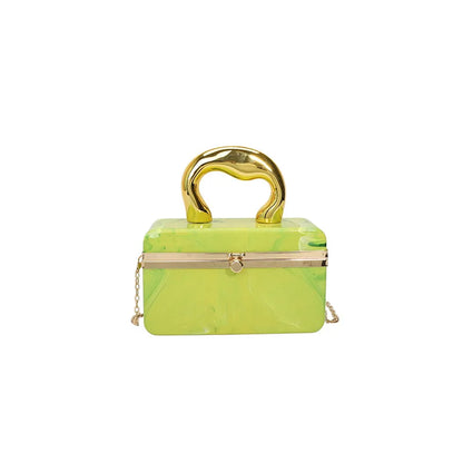 Green handbag with gold accents on a white background