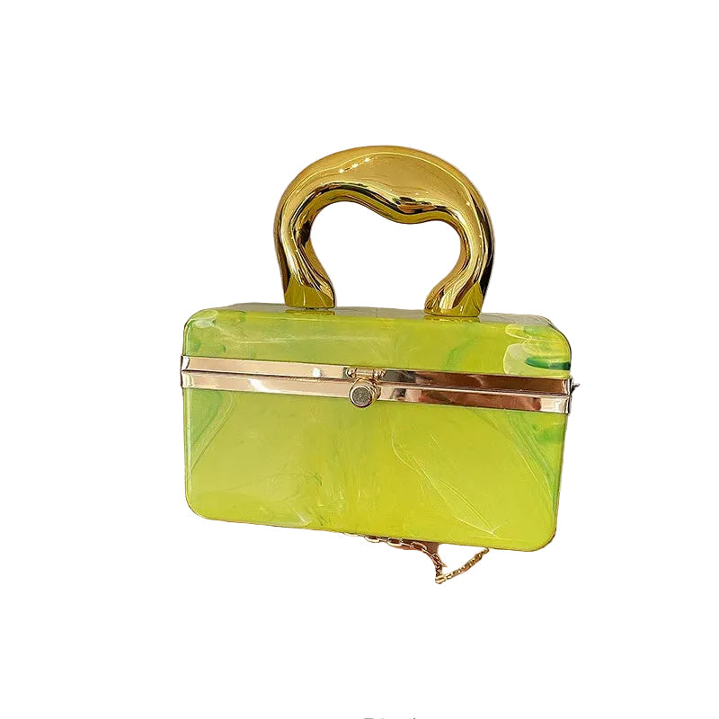 Yellow marbled handbag with gold accents on a white background