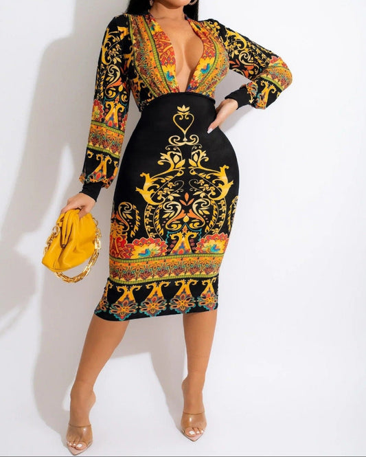 Woman wearing a colorful patterned dress with a yellow clutch against a white background