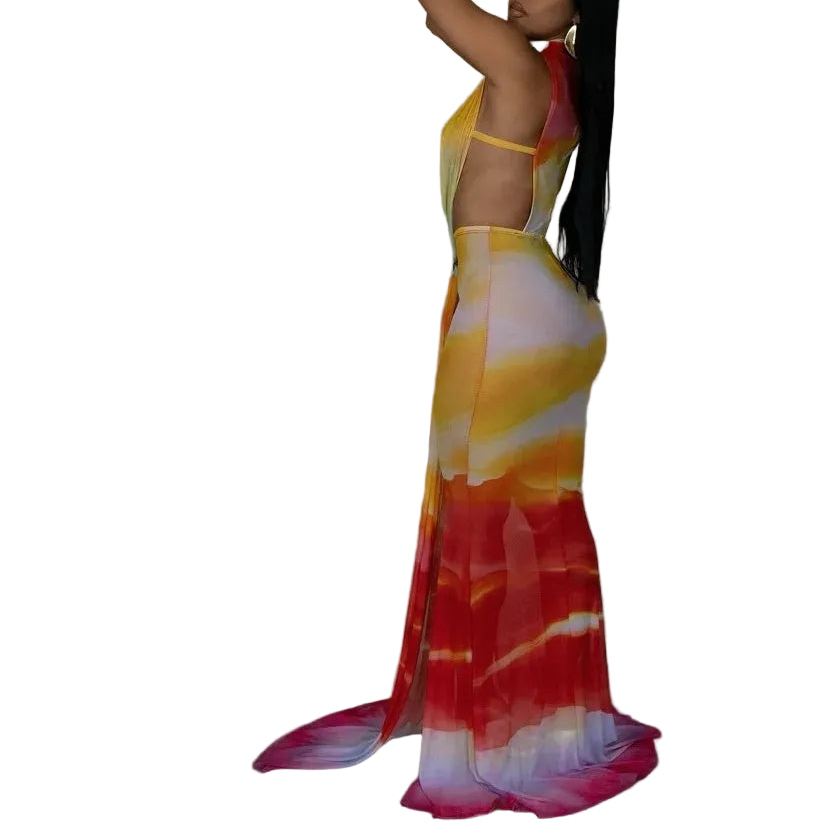 Woman in a colorful dress with a palm leaf against a plain background, featuring the brand 'GLCMYAYA'.