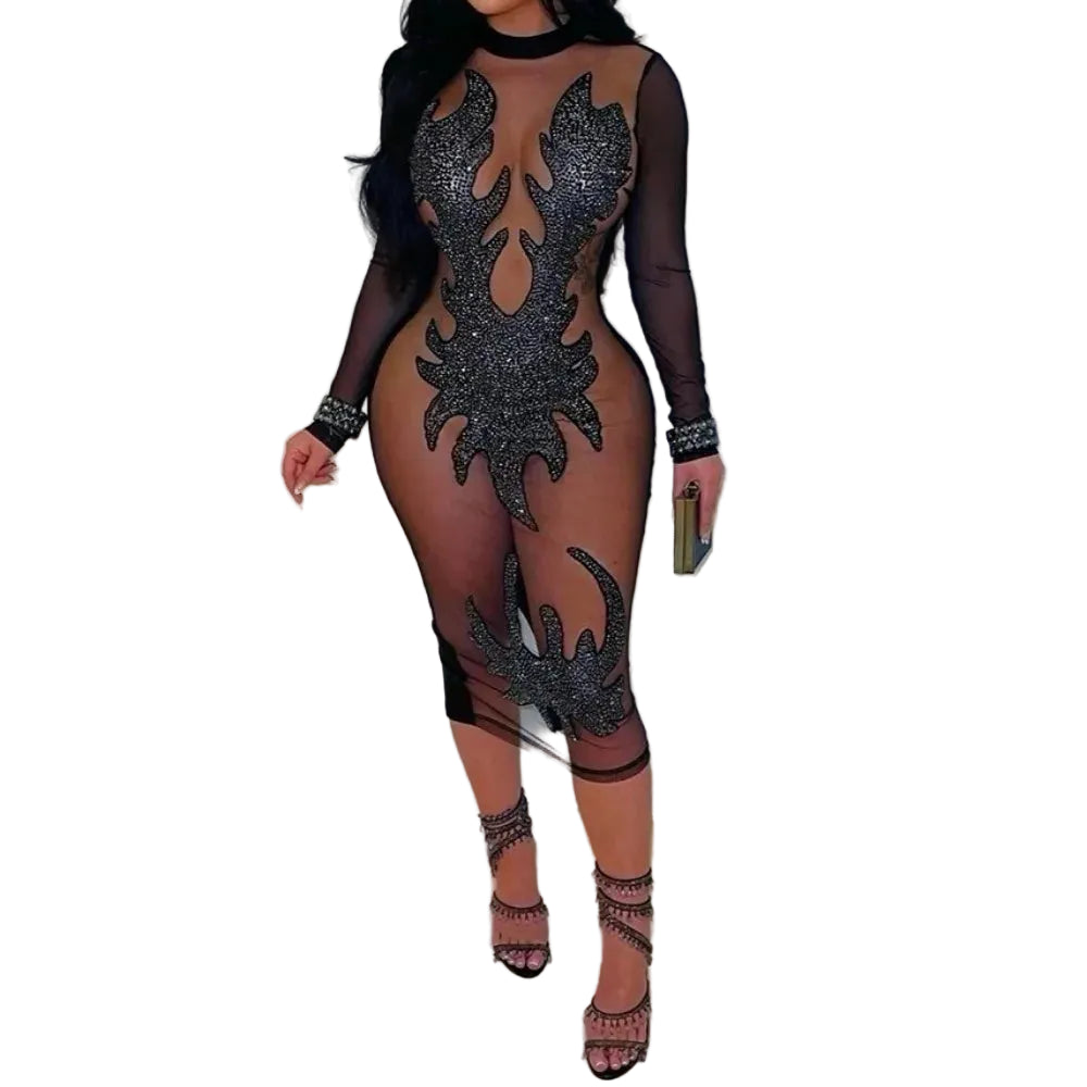 Sheer black dress with intricate designs worn by a model against a white background
