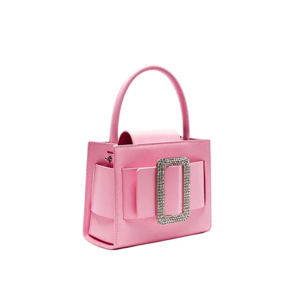 Pink handbag with decorative clasp on a light gray background, featuring the brand 'Bafelli'.
